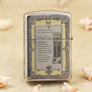 Ornate chrome Zippo-style lighter on a sandy beach with seashells nearby.