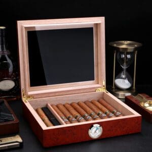 Open wooden cigar humidor revealing a row of cigars and a round humidity gauge on the front panel