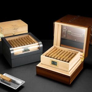 Luxury wooden cigar humidor with glass lid, open to reveal neatly packed cigars and a digital humidity gauge reading around 70%.