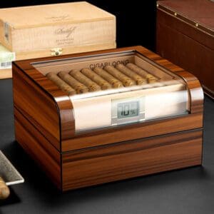 Wood cigar humidor with cigars neatly arranged inside and a digital humidity gauge on the front